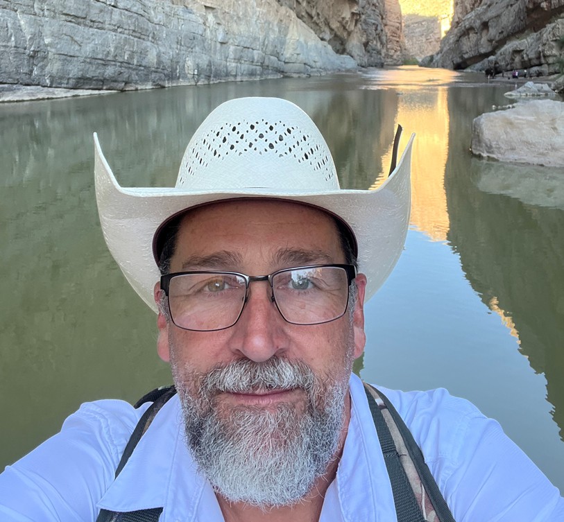 Man with beard in cowboy had on Rio Grande River in Santa Elena Canyon