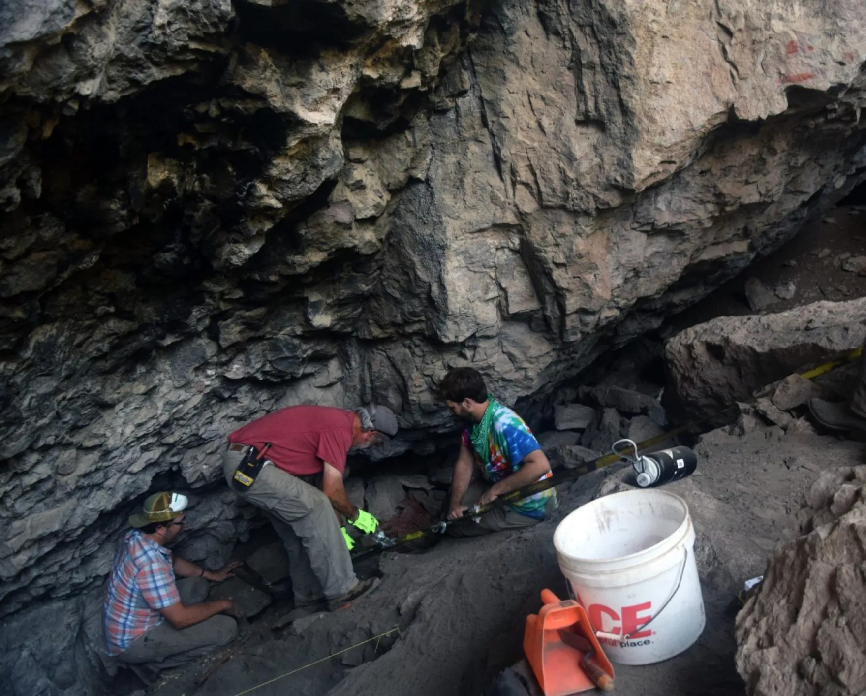 Center director Bryon Schroeder, left, and archeological volunteers excavate in Presidio County’s San Esteban Cave.