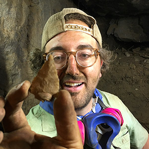 Bryon Schroeder with arrow point found in cave